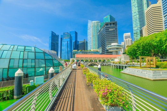 Singapore - April 28, 2018: glass dome of Fullerton Pavilion on Marina Bay Central Business District or CBD Buildings and Clifford Square in Marina Bay promenade Singapore. Sunny day with blue sky.