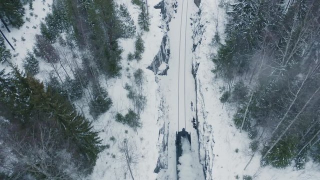 Aerial top down view steam train running in forest