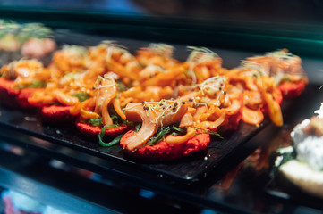 A wide variety of traditional tapas with seafood in Spain at the San Miguel market