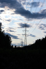 Power line in evening landscape with dramatic clouds