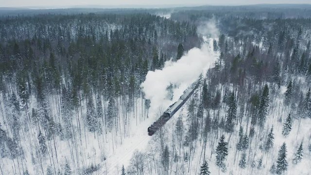 Aerial view steam train in winter forest