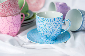 Tea set of mugs and saucers on a light background, selective focus
