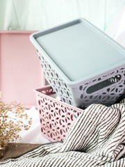 Plastic boxes with lids for storing household items on a light background
