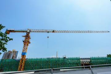 a giant crane with its long arm at full-length, shot in a university construction site in shenzhen china