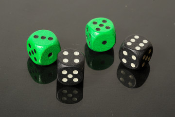dice on a black background with reflection