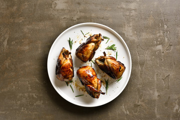 Baked quails on plate