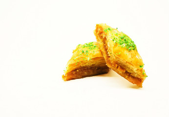 Pieces of honey baklava on a light background with space for text.