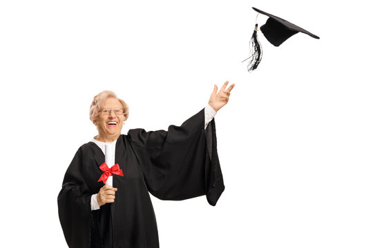 Happy mature female graduate throwing hat and holding a diploma