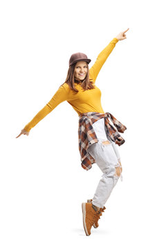 Young woman in casual clothes dancing on tiptoes