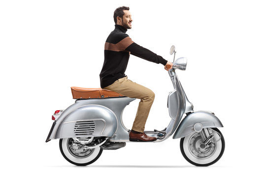 Elegant trendy man riding a silver vintage scooter