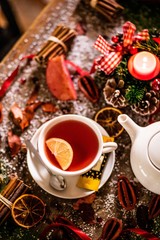 Obraz na płótnie Canvas hot tea with lemon on christmas 