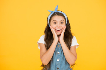 summer kid fashion. beauty and fashion. happy childhood. surprised after hairdresser. little beauty with handkerchief long curly hair. retro child yellow background. small girl vintage look