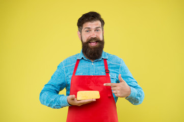 reasonable price and good quality. cheesemaking techniques. cheese maker. hipster with beard in chef apron. Dairy food shop. Online shopping. Gourmet product. happy bearded man hold cheese