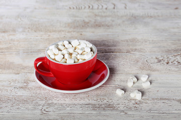 A large red cup with coffee and marshmallows. View from above. Copy space. Still life concept.