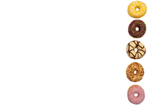 various colored delicious donuts on white background, space for text © annebel146