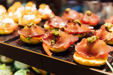 Obraz premium A wide variety of traditional tapas with seafood in Spain at the San Miguel market