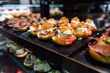 Naklejka premium A wide variety of traditional tapas with seafood in Spain at the San Miguel market