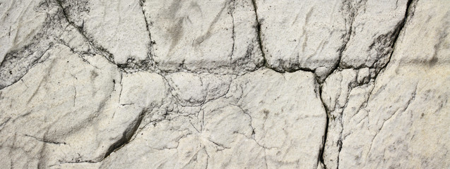 Texture of white stone with cracks