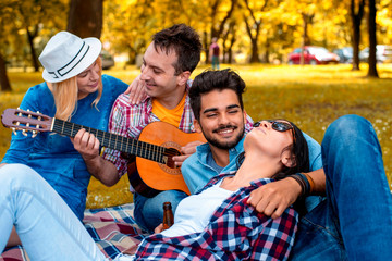 Group of friends in autumn park  enjoying time together