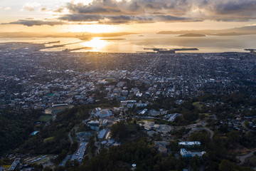 A serene sunset illuminates the densely populated San Francisco Bay area including Oakland,...