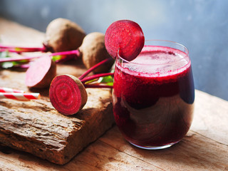 Beetroot juice in a glass with sliced beetroot on top for healthy drinks concept.