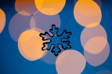 Transparent snow flake against blurred lights