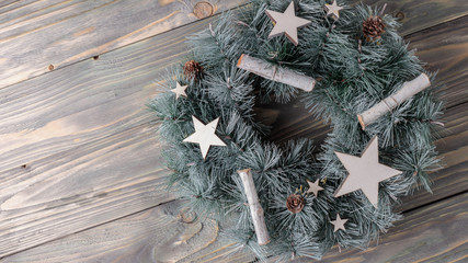 Holiday decorations with Christmas wreath on an old wooden background