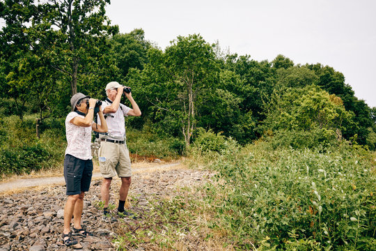 Senior couple looking through binoculars