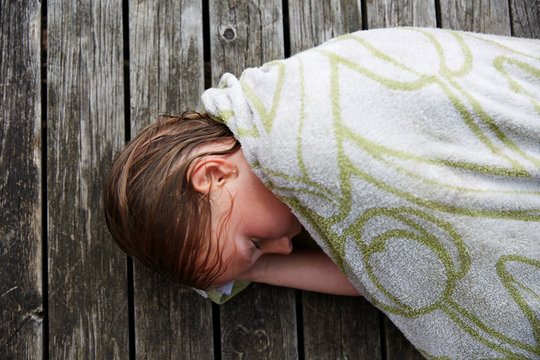 Girl wrapped in towel sleeping