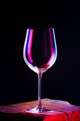 Empty glass for a wine on wooden table and dark background