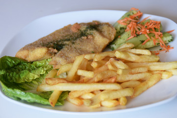 fries and a salad of fresh cucumber and grated carrot fried fish