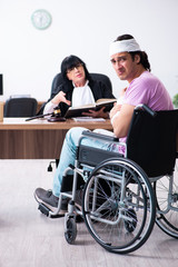 Disabled man consulting judge for damages litigation
