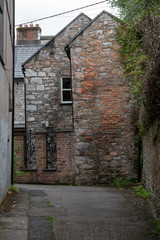 Fototapeta na wymiar View of empty alley amidst old Victorian buildings, City of Cork, County Cork, Ireland