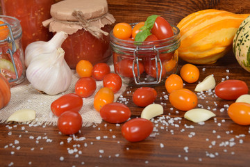 cocktail tomatoes, garlic, spices, colorful pumpkins and scattered kitchen salt