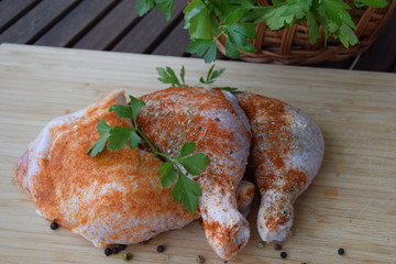 chicken legs in spices with tomatoes, herbs, parsley and hot peppers on the grill