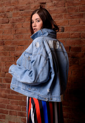 Naklejka premium Fashionable photo. Girl model in fashionable clothes, studio shooting.