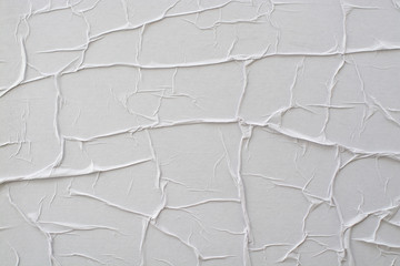 White paper glued on the wall close-up.