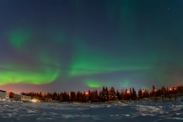 Fototapeta na wymiar Aurora borealis in night northern sky. Ionization of air particles in the upper atmosphere.