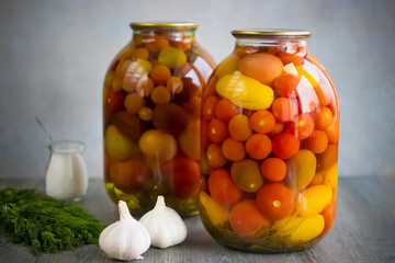 Pickled tomatoes in a glass jar.