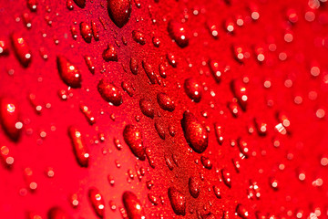 Water drops on a red surface texture