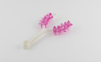 pink plastic universal massager on a white background. with space for text