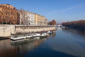 Naklejka premium Embankment of the Tiber River in historic center of Rome in sunny winter day, Italy