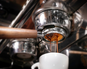 Fototapeta na wymiar Making espresso coffee in coffeeshop or cafe closeup