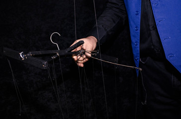 Puppeteer Hands Holding the Wooden Handle Mast over Black Blackground