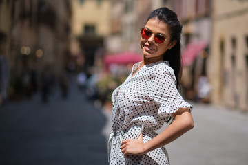 beautiful woman walking and running joyful and cheerful smiling in Tuscany, Italy.