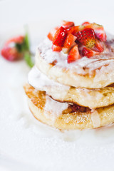 Strawberry pancakes with sour cream isolated on white background close-up. Traditional sweet and unhealthy american food with a lot of sugar.