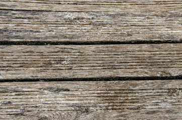 gray wooden background. Old dry boards. Wood texture. bridge or pier in the village near the river.