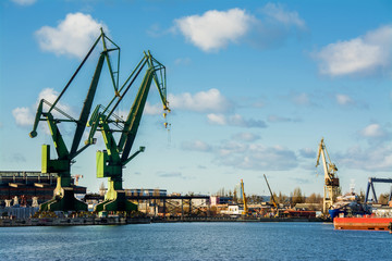 View of the shipyard with historical cranes in the industrial part of the city Gdansk (Gdańsk) in...