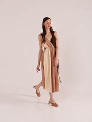 Fototapeta premium Fashionable photo. Girl model in fashionable clothes, studio shooting.