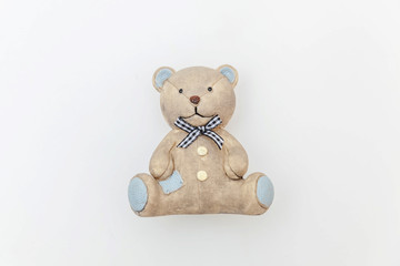 Simply minimal design with toy bear isolated on white background. Children care materinity family concept. Flat lay, top view, copy space